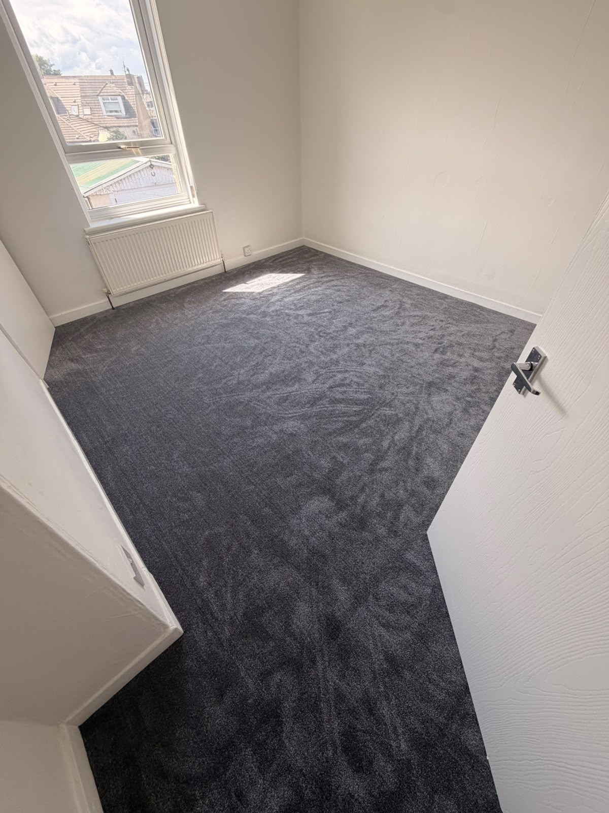 Dark grey saxony carpet fitted in a bright bedroom