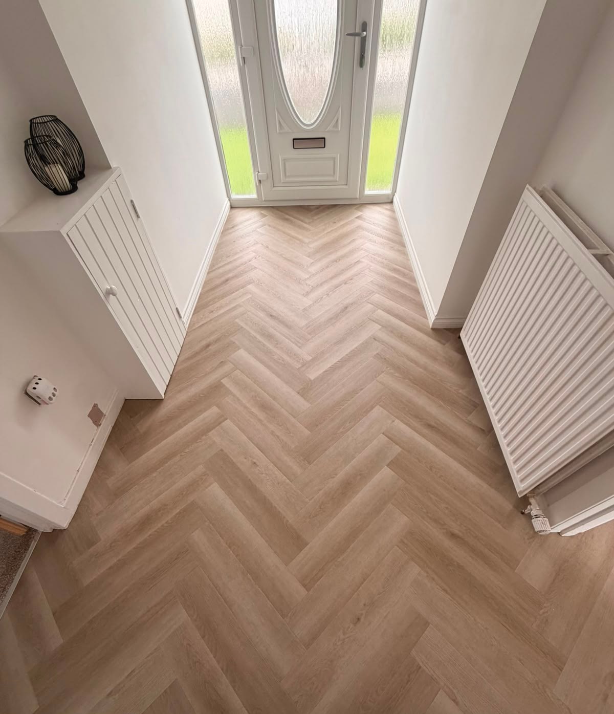 Herringbone LVT laid through a hallway to the front door