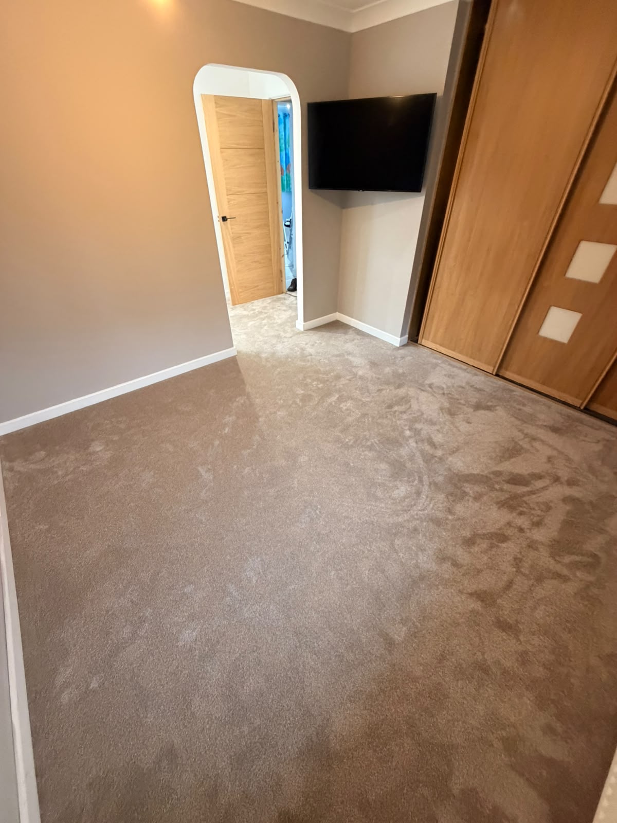 Mink saxony carpet fitted wall to wall in a bedroom with oak wardrobes